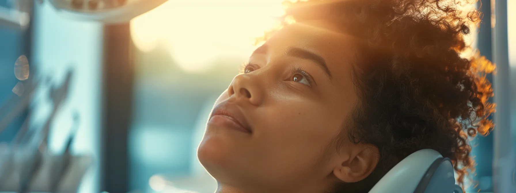 a focused close-up of a concerned patient in a modern dental clinic, illuminated by soft, warm lighting, reflecting the urgency of seeking an emergency dentist in dallas.